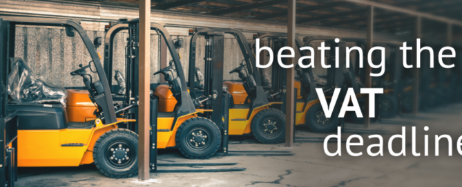 A digital banner displaying the words ' beating the VAT deadline' in large text, with forklift tracks in the background