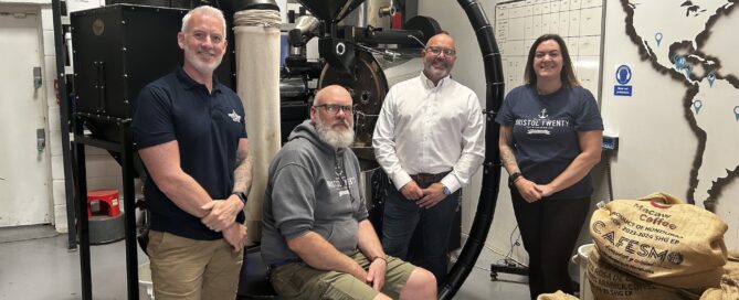 A image of a group of 4 people smiling at the camera wear bristol twenty clothing