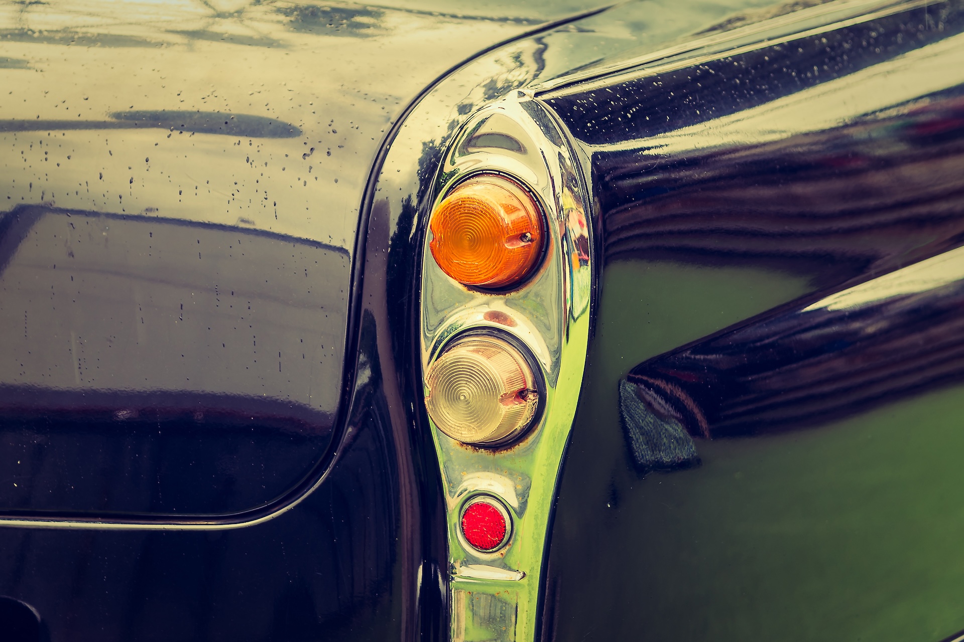 A close up image of the headlights of a vintage classic car