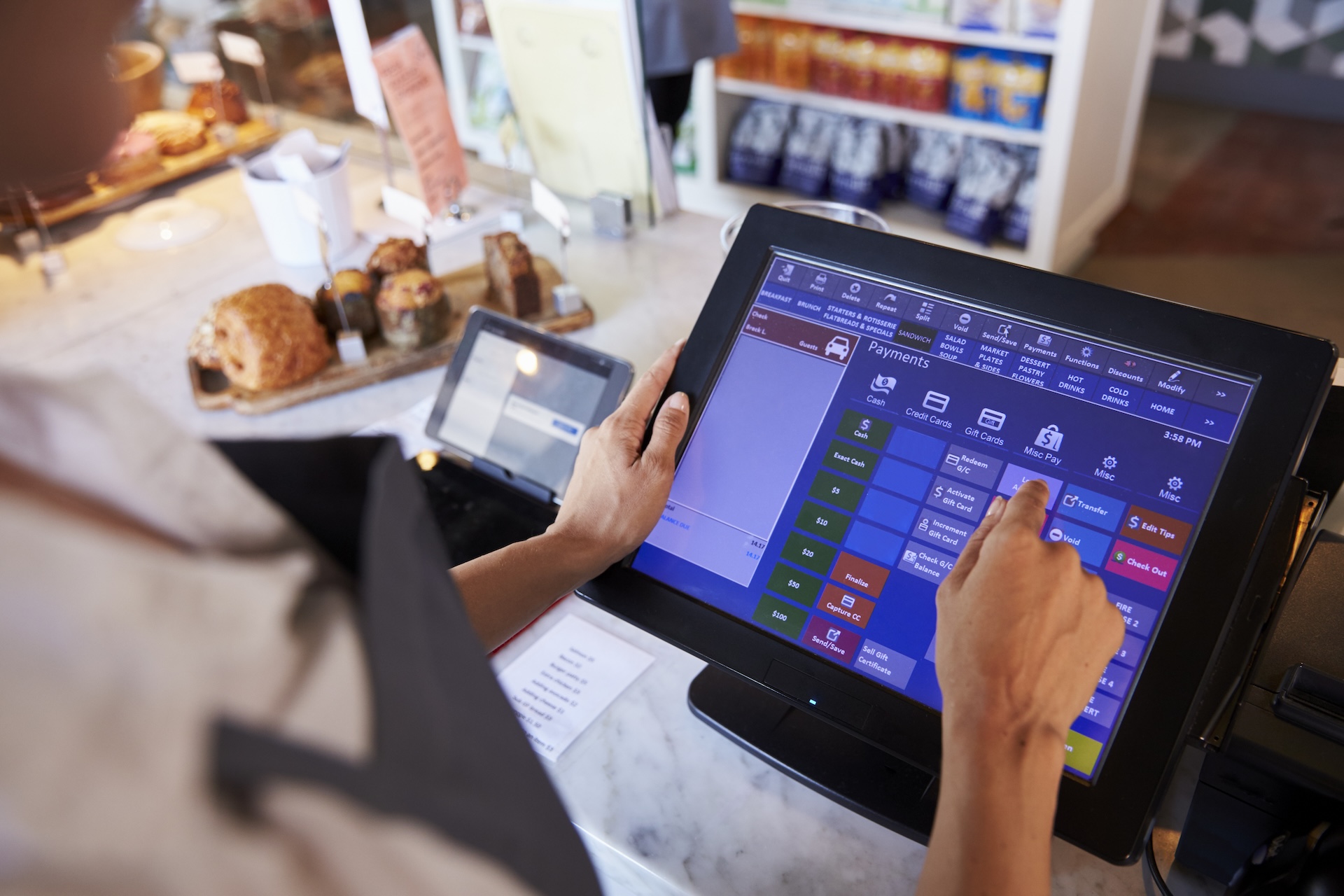 Close up image of a female employee working at a delicatessen checkout