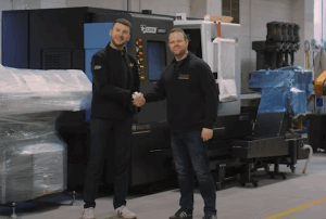 Images of two men in a factory setting shaking hands