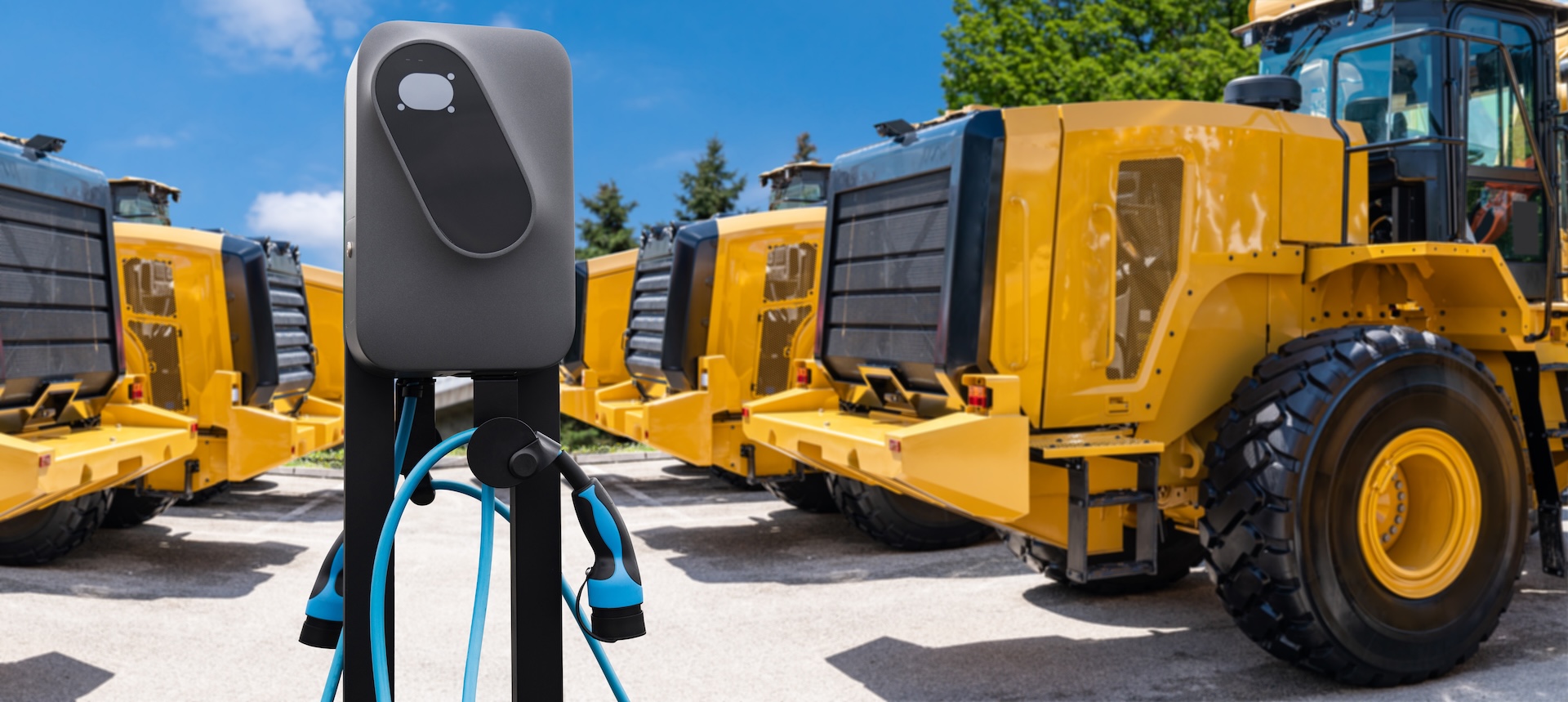Electric,Construction,Machines,With,Charging,Station.,Concept Image of electric-powered construction machinery on a worksite, symbolizing sustainable or green industrial equipment.