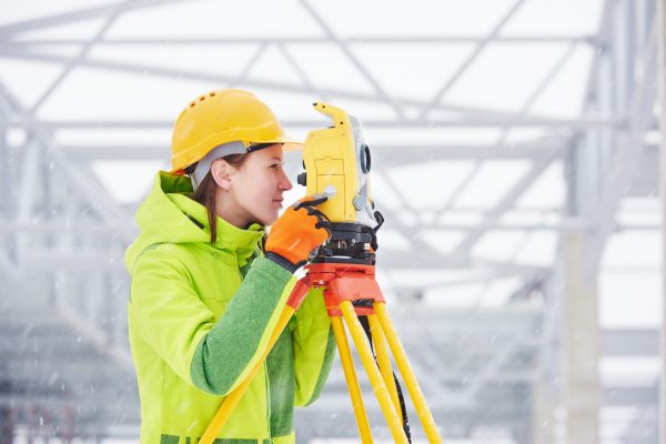 Female,Surveyor,Worker,Working,With,Theodolite,Transit,Equipment,At,Road