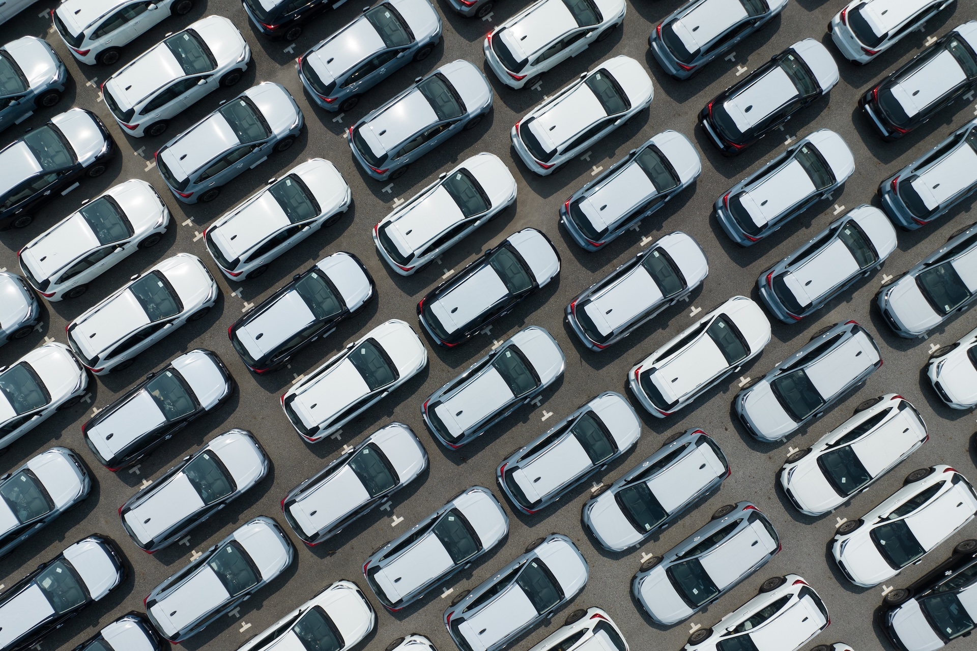 Aerial,View,Of,New,Cars,Stock,At,Factory,Parking,Lot. A ime of an aerial view of new cars stock at factory parking lot.
